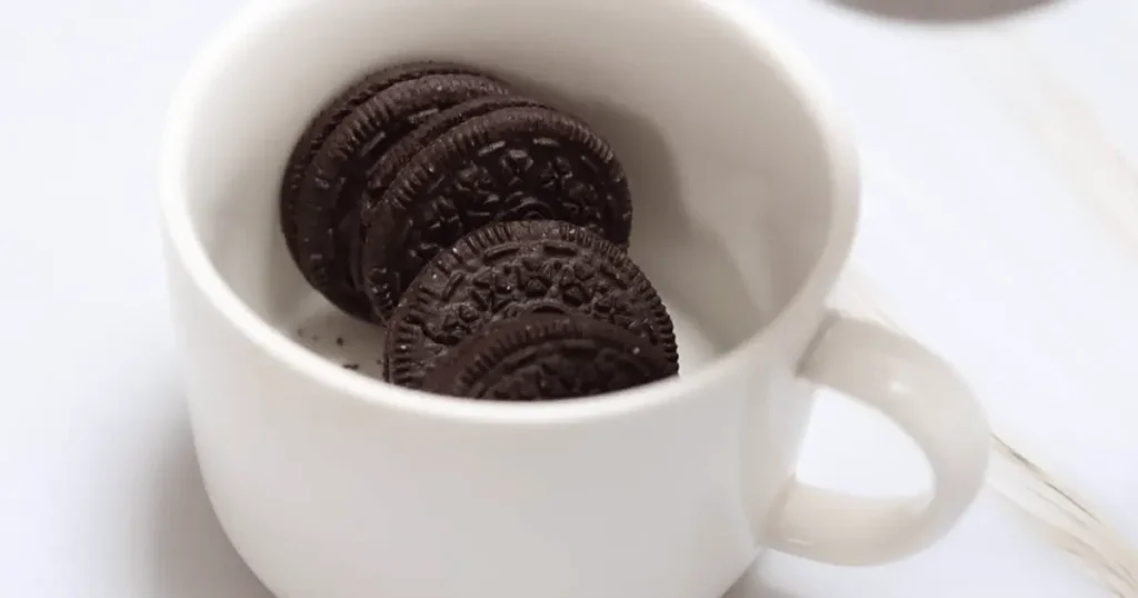 Indulgent Oreo mug cake topped with creamy whipped cream, a delightful treat in a mug