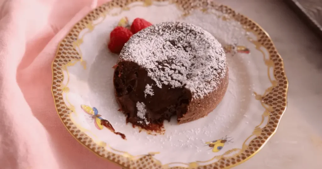 Decadent chocolate lava cake with a molten center, served warm and topped with a scoop of vanilla ice cream and a drizzle of chocolate sauce, a delightful dessert for chocolate lovers.