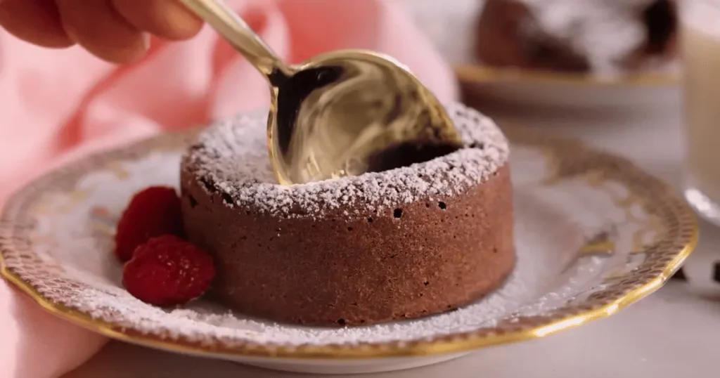 Decadent chocolate lava cake with a molten center, served warm and topped with a scoop of vanilla ice cream and a drizzle of chocolate sauce, a delightful dessert for chocolate lovers.