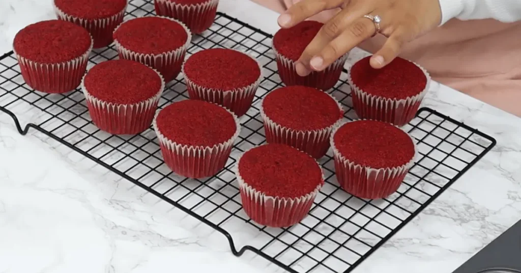 Delicious homemade red velvet cupcakes with creamy cream cheese frosting, garnished with chocolate shavings and fresh strawberries, perfect for special occasions and indulgent treats.