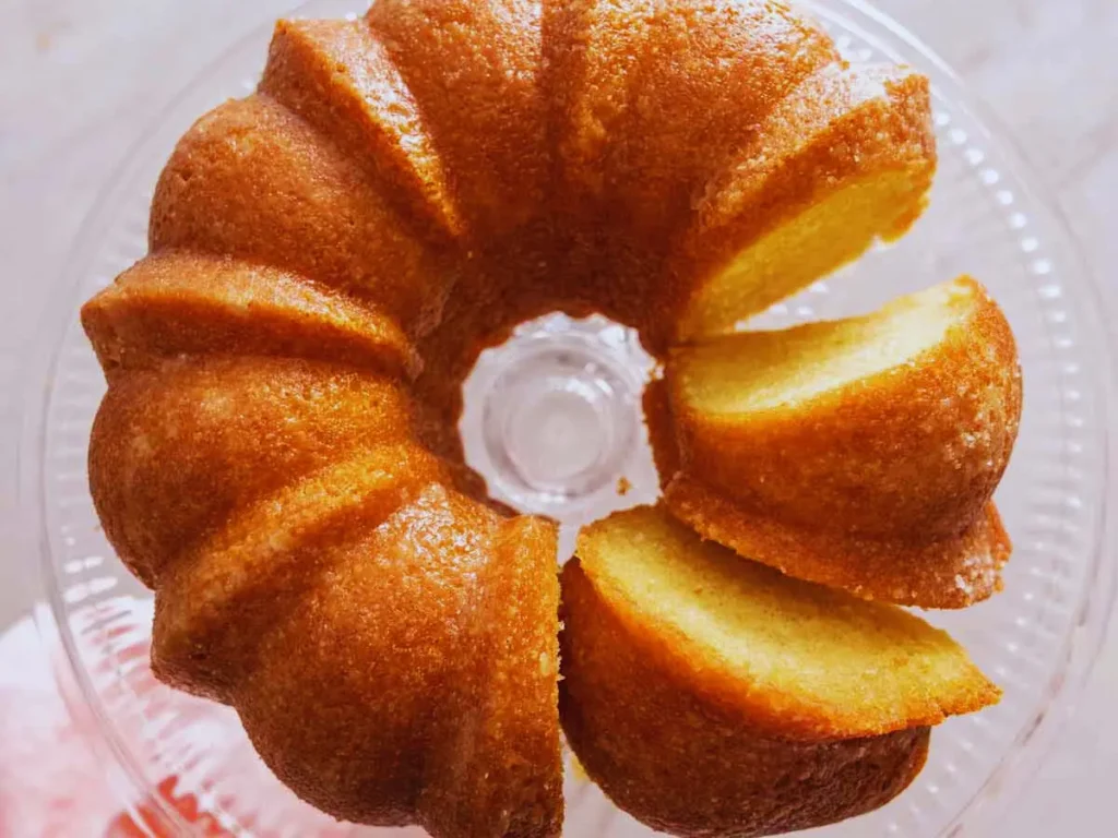 Delicious homemade butter cake with golden crust, served on a white plate, perfect dessert recipe for any occasion